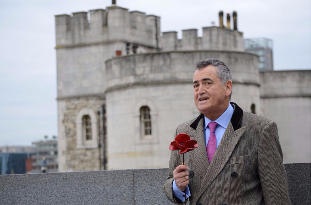Christopher West holding a poppy at The Tower of London